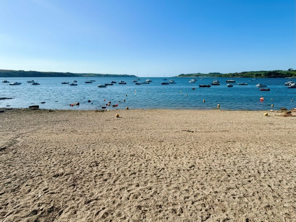 A beach scene with boats on water at The Studio in Feock near Truro