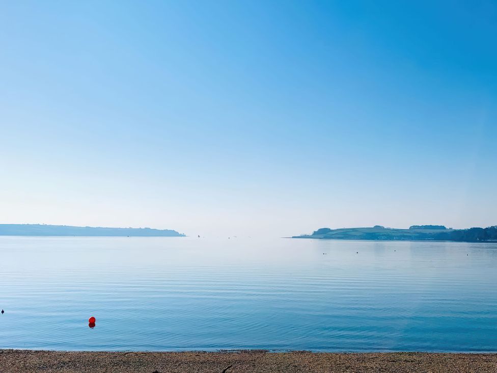 A view of calm water with a buoy at The Studio in Feock near Truro