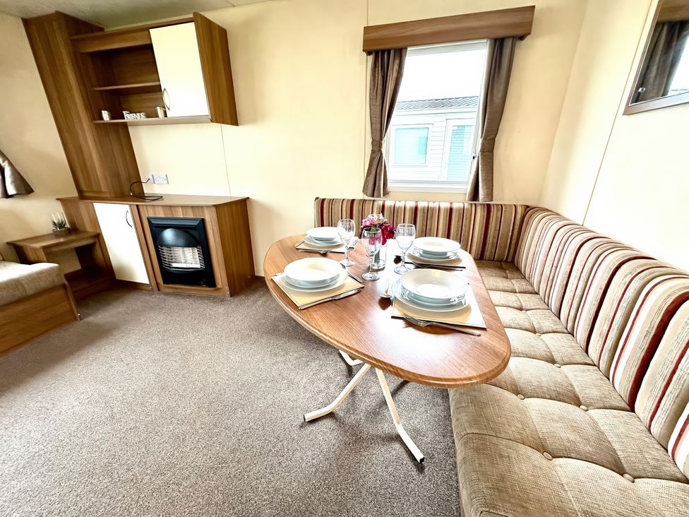 A dining area with a table set for meals at Chamki Lodge in Whitley Bay