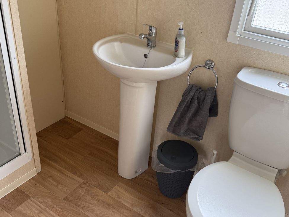 A bathroom with a sink and toilet at Chamki Lodge in Whitley Bay