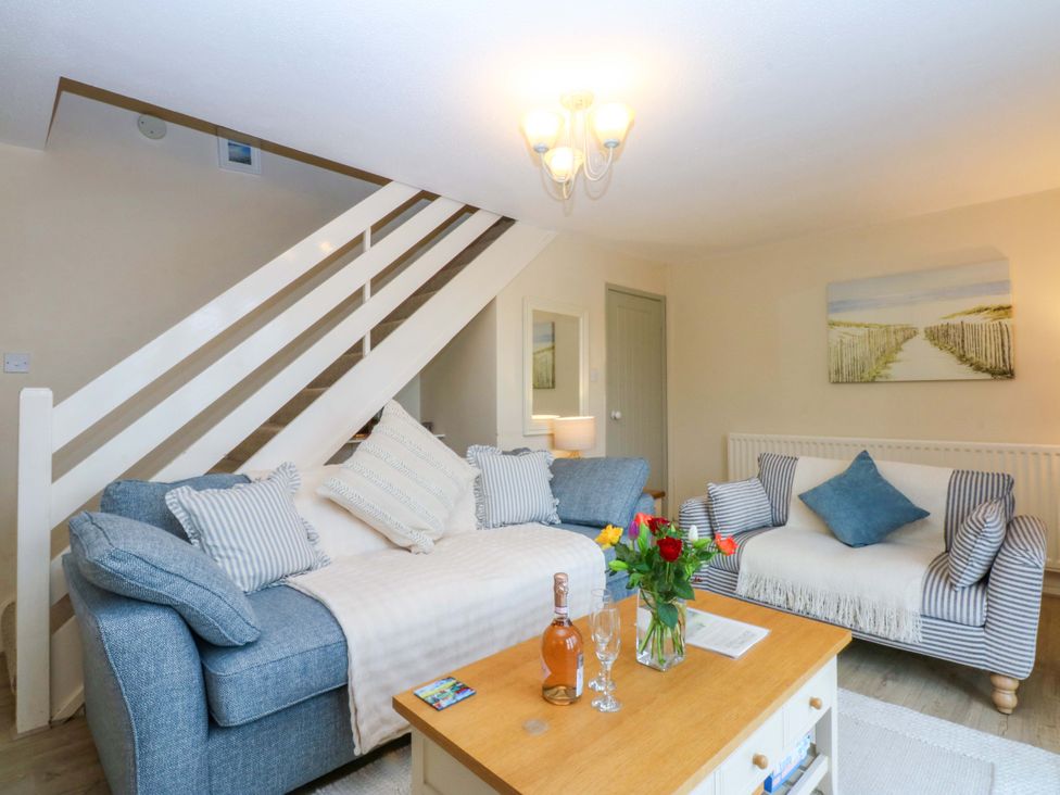 A living room with a sofa and coffee table at The Cottage On The Green Borth-Y-Gest