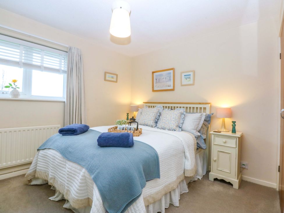 A bedroom with a double bed and a nightstand at The Cottage On The Green Borth-Y-Gest