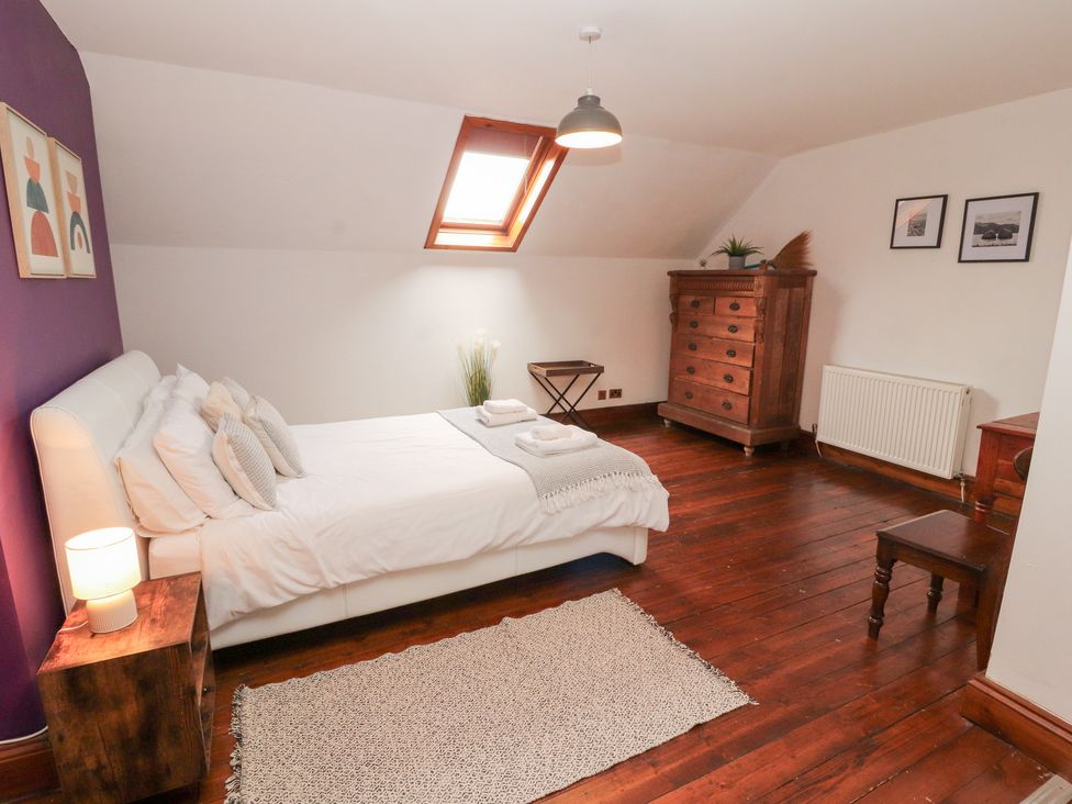 A bedroom with a bed and dresser at 1 Cleator Gate in Cleator