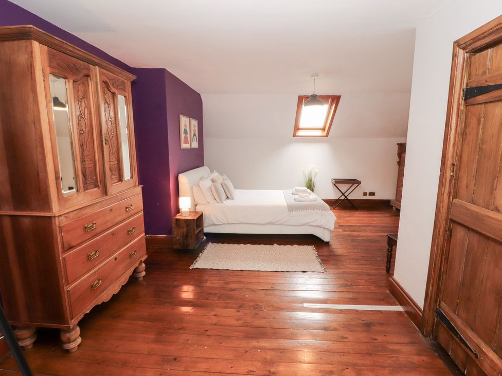 A bedroom with a bed and wardrobe at 1 Cleator Gate in Cleator