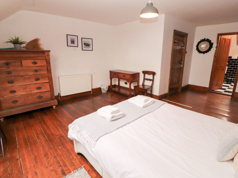 A bedroom with a bed and furniture at 1 Cleator Gate in Cleator