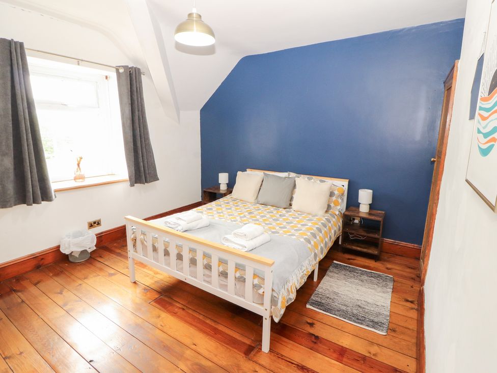 A bedroom with a bed and bedside table at 1 Cleator Gate in Cleator