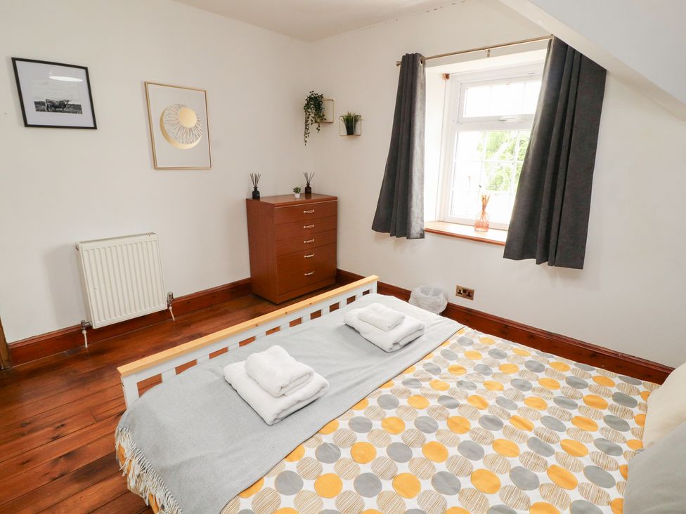 A bedroom with a bed and dresser at 1 Cleator Gate Cleator