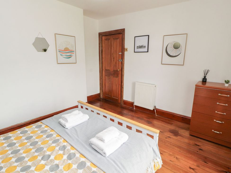 A bedroom with a bed and towels on it at 1 Cleator Gate in Cleator