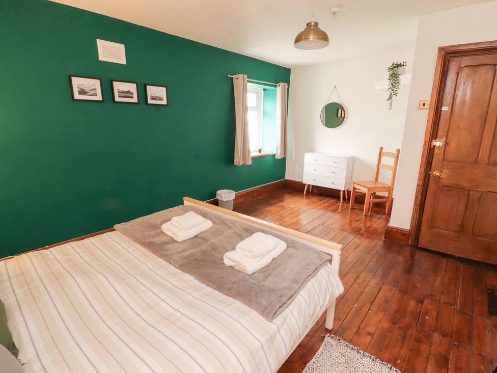 A bedroom with a bed and dresser at 1 Cleator Gate in Cleator