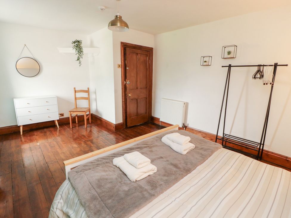 A bedroom with a bed and dresser at 1 Cleator Gate in Cleator