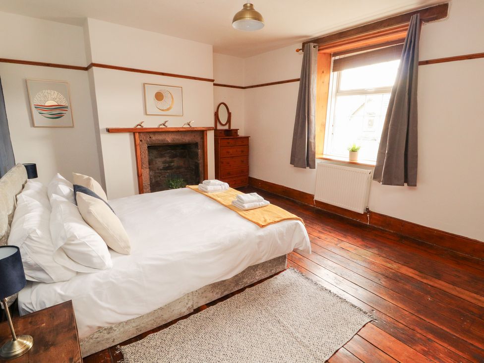 A bedroom with a bed and window at 1 Cleator Gate in Cleator