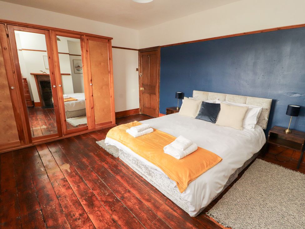 A bedroom with a bed and wardrobe at 1 Cleator Gate in Cleator