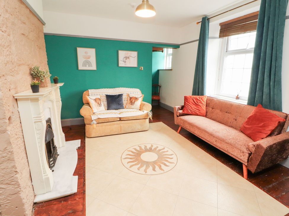 A living room with furniture and wall decor at 1 Cleator Gate in Cleator