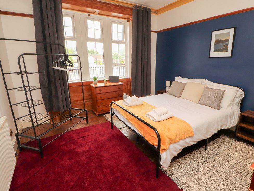 A bedroom with a bed and dresser at 1 Cleator Gate in Cleator