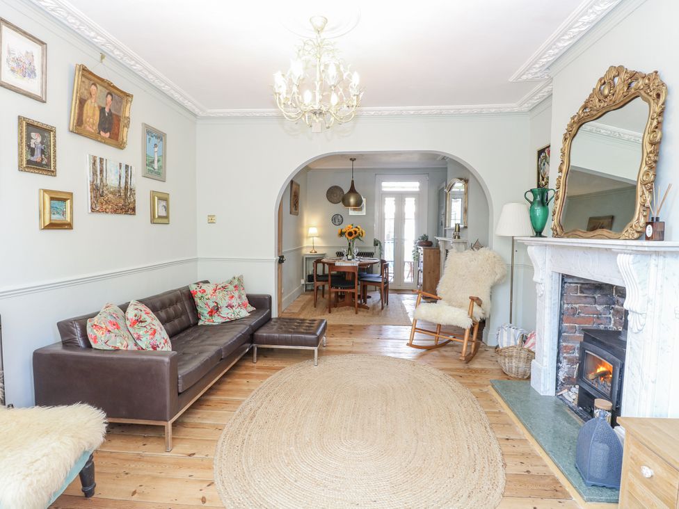 A living room with a sofa and a dining area at 18 Pakefield Road in Lowestoft