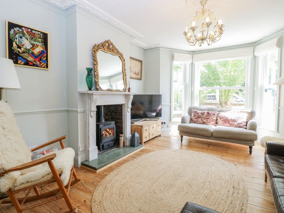 A living room with a fireplace and a sofa at 18 Pakefield Road in Lowestoft