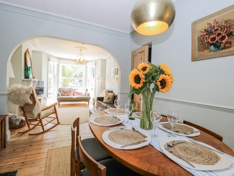 A dining room with a table set for dinner at 18 Pakefield Road in Lowestoft