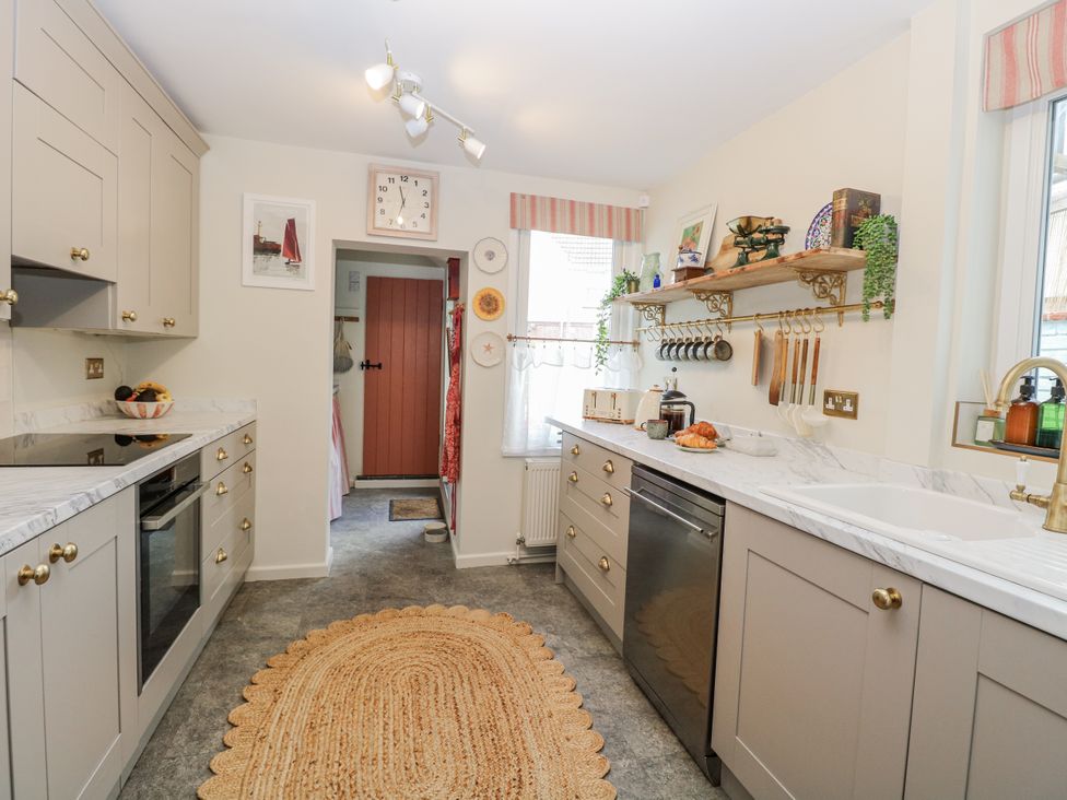 A kitchen with cabinets and a sink at 18 Pakefield Road in Lowestoft