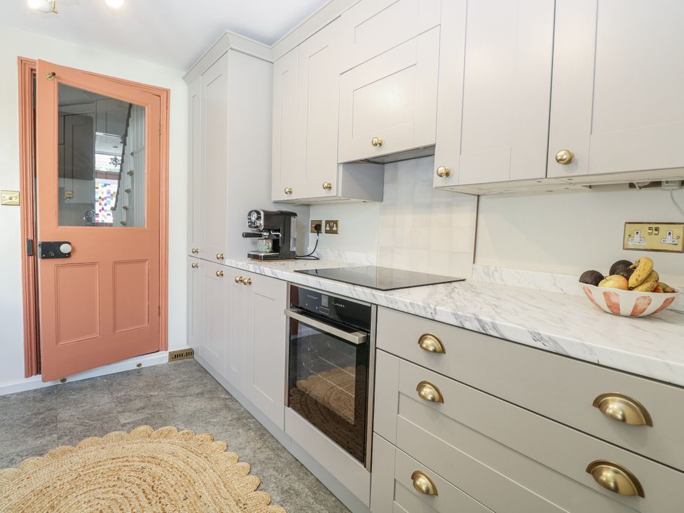 A kitchen with a stove and coffee machine at 18 Pakefield Road in Lowestoft