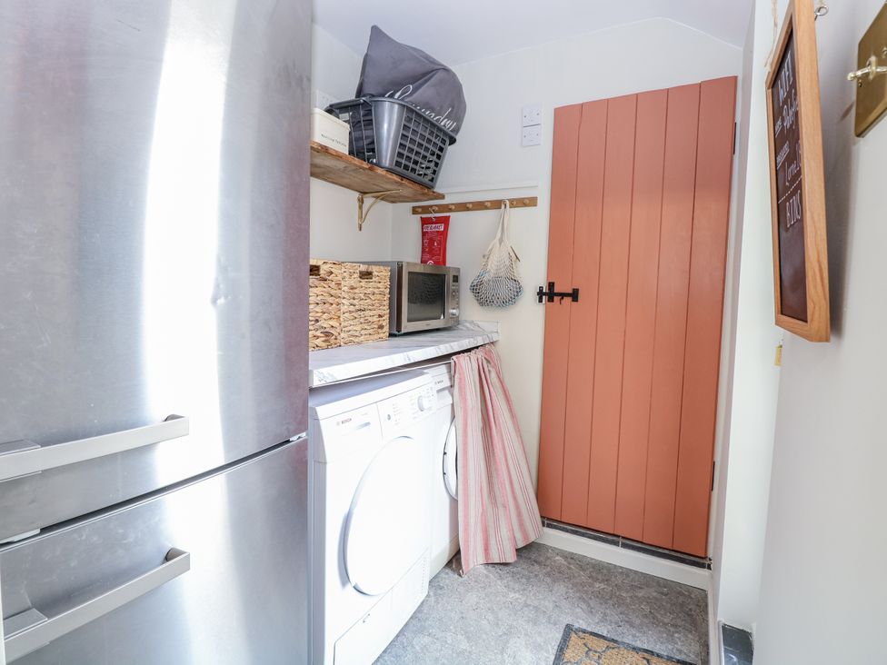 A laundry room with appliances at 18 Pakefield Road in Lowestoft