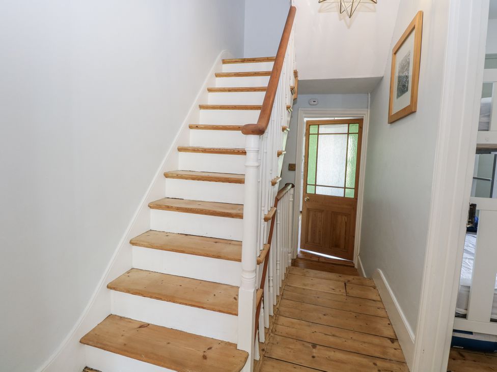 A hallway with stairs and a front door at 18 Pakefield Road in Lowestoft