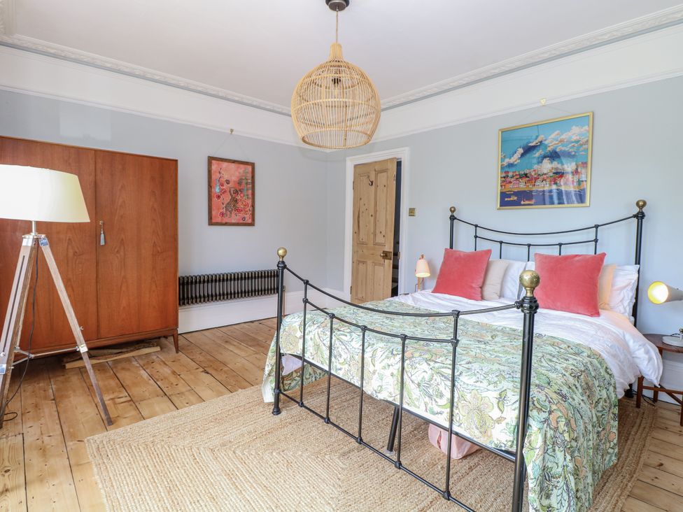 A bedroom with a bed and wardrobe at 18 Pakefield Road in Lowestoft