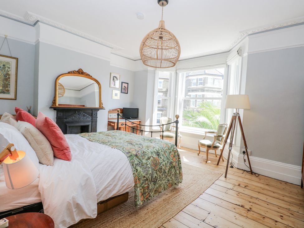 A bedroom with a bed and chairs at 18 Pakefield Road Lowestoft