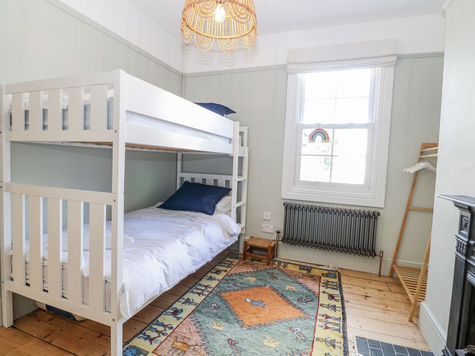 A bedroom with a bunk bed and a single bed at 18 Pakefield Road in Lowestoft