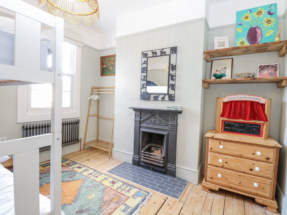 A bedroom with a bunk bed and a fireplace at 18 Pakefield Road in Lowestoft