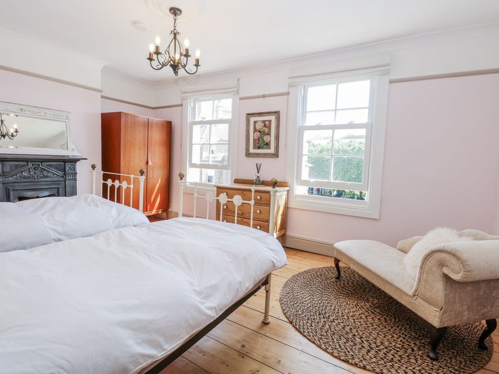 A bedroom with a bed and wardrobe at 18 Pakefield Road in Lowestoft
