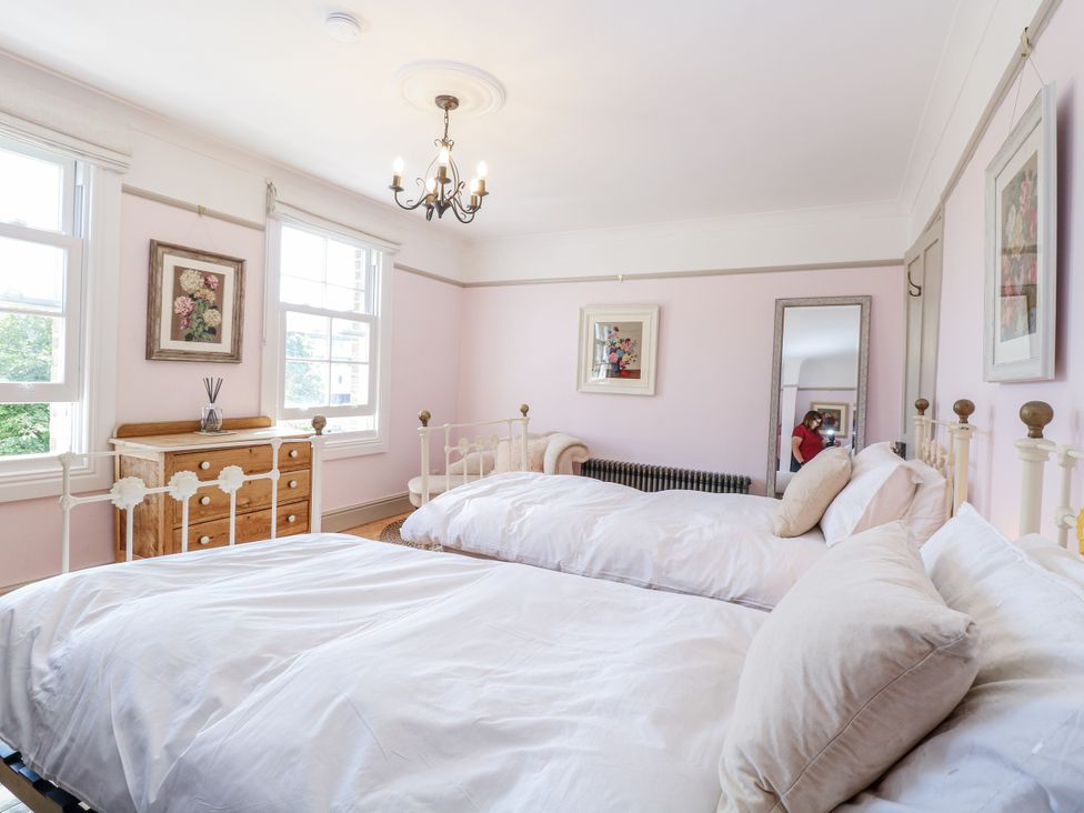 A bedroom with two beds and a dresser at 18 Pakefield Road in Lowestoft