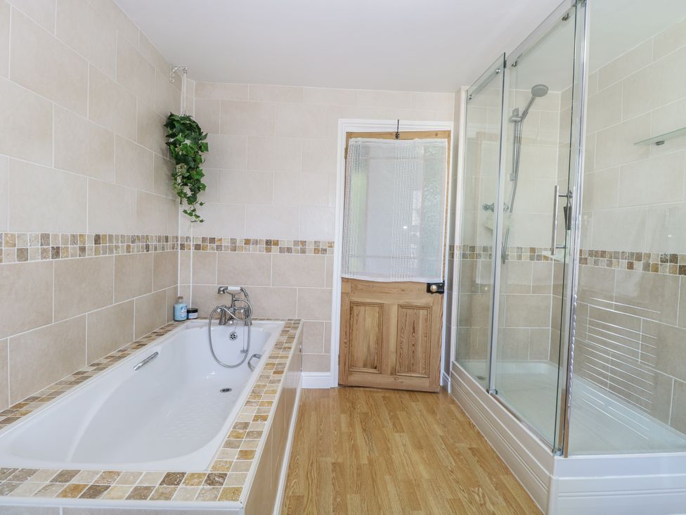 A bathroom with a bathtub and shower at 18 Pakefield Road in Lowestoft