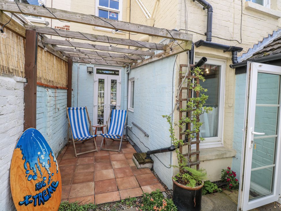 An outdoor area with deck chairs and a table at 18 Pakefield Road in Lowestoft