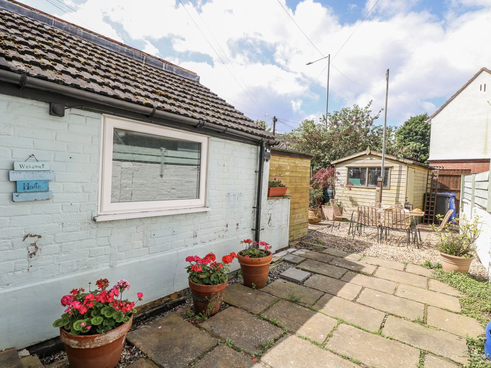 A garden with flower pots and a shed at 18 Pakefield Road in Lowestoft