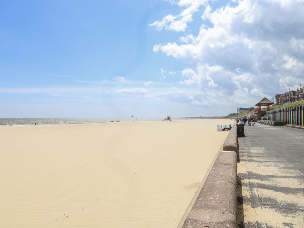 A beach with a promenade and coastal buildings at 18 Pakefield Road in Lowestoft