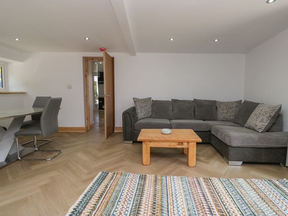 A living room with a sofa and coffee table at the Old Post Office Cottage in Ulverston