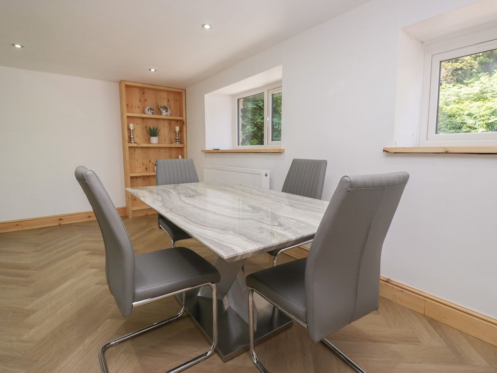 A dining room with a table and chairs at Old Post Office Cottage Ulverston
