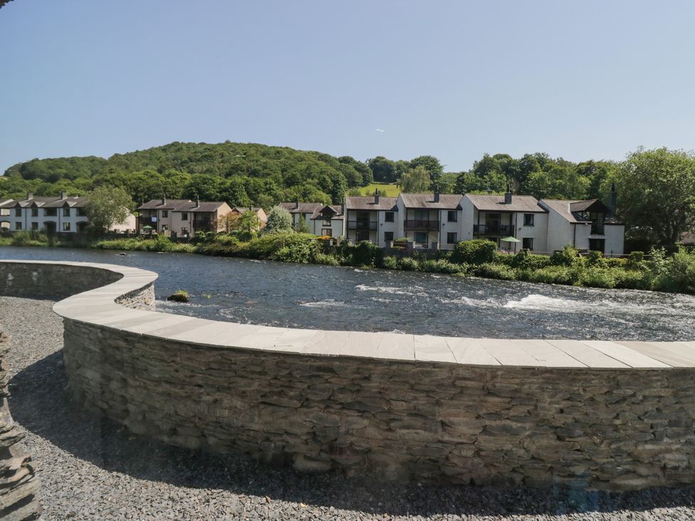 A view of houses and a river in Ulverston at Old Post Office Cottage
