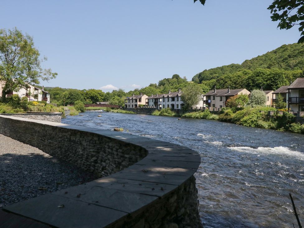 A view of a river with houses and trees in Ulverston