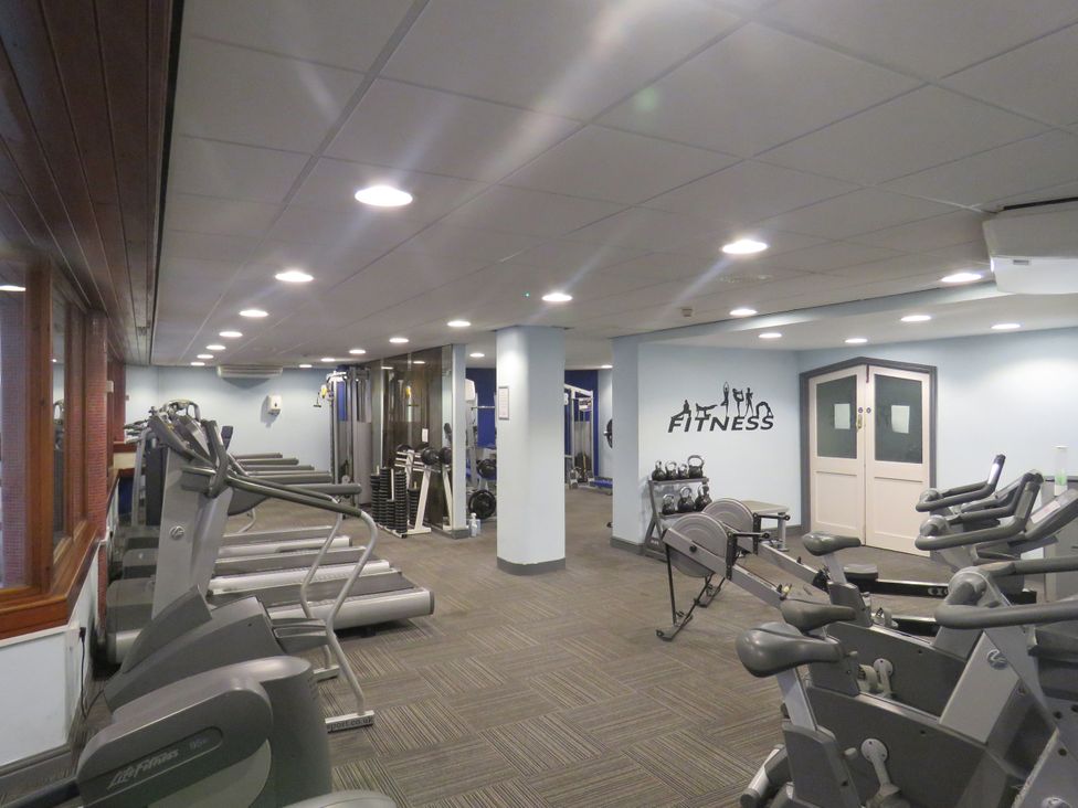 A gym with various fitness equipment at Old Post Office Cottage Backbarrow near Newby Bridge