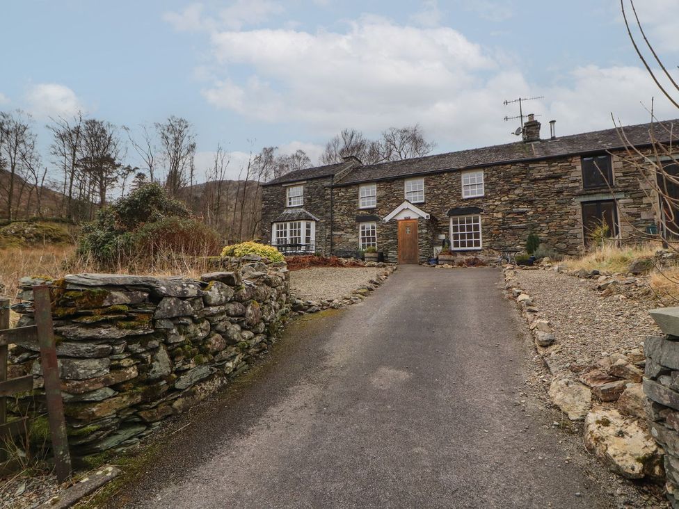A stone house with windows and door at Deer How Farm Patterdale near Glenridding