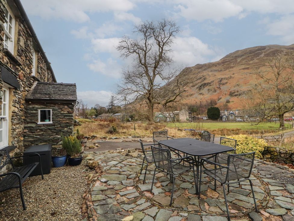 A patio area with a table and chairs at Deer How Farm Patterdale near Glenridding
