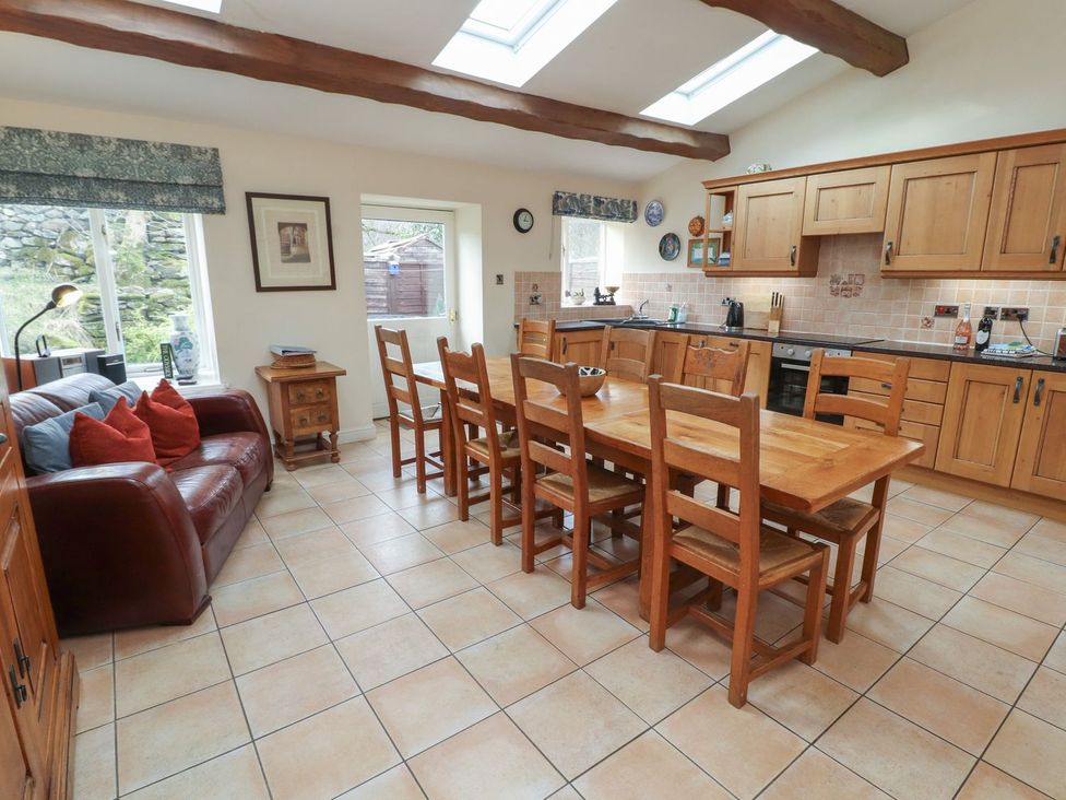 A kitchen with a dining table and chairs at Deer How Farm in Patterdale near Glenridding