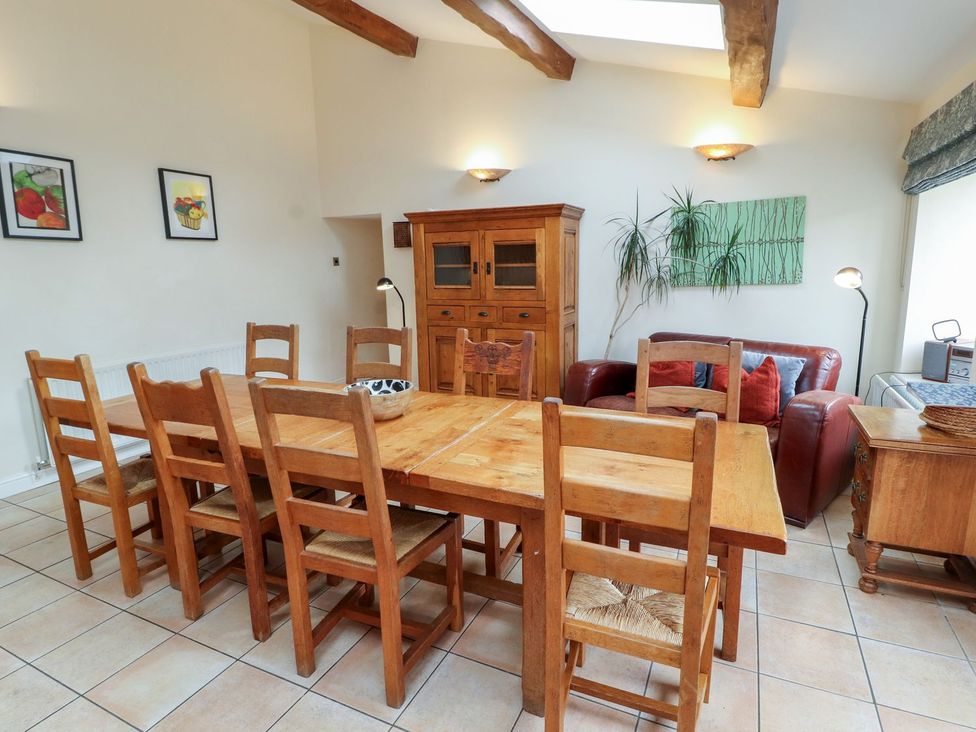 A dining room with a table and chairs at Deer How Farm near Patterdale