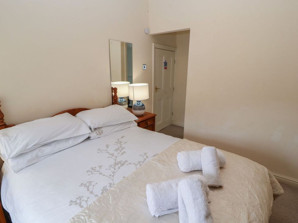 A bedroom with a bed and lamps at Deer How Farm Patterdale near Glenridding