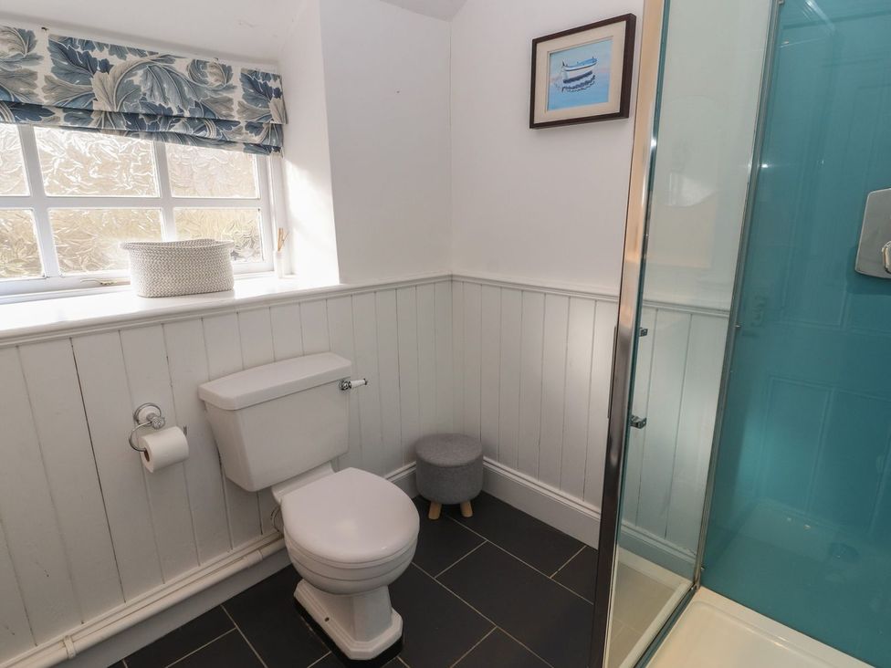 A bathroom with a toilet and shower at Deer How Farm Patterdale near Glenridding