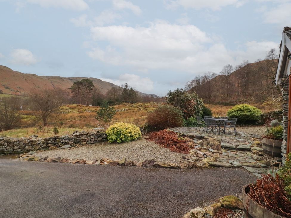 An outdoor area with stone path and patio furniture at Deer How Farm near Patterdale