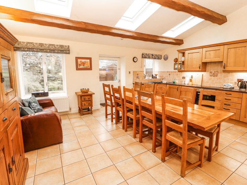 A kitchen with a table and chairs at Deer How Farm Patterdale near Glenridding