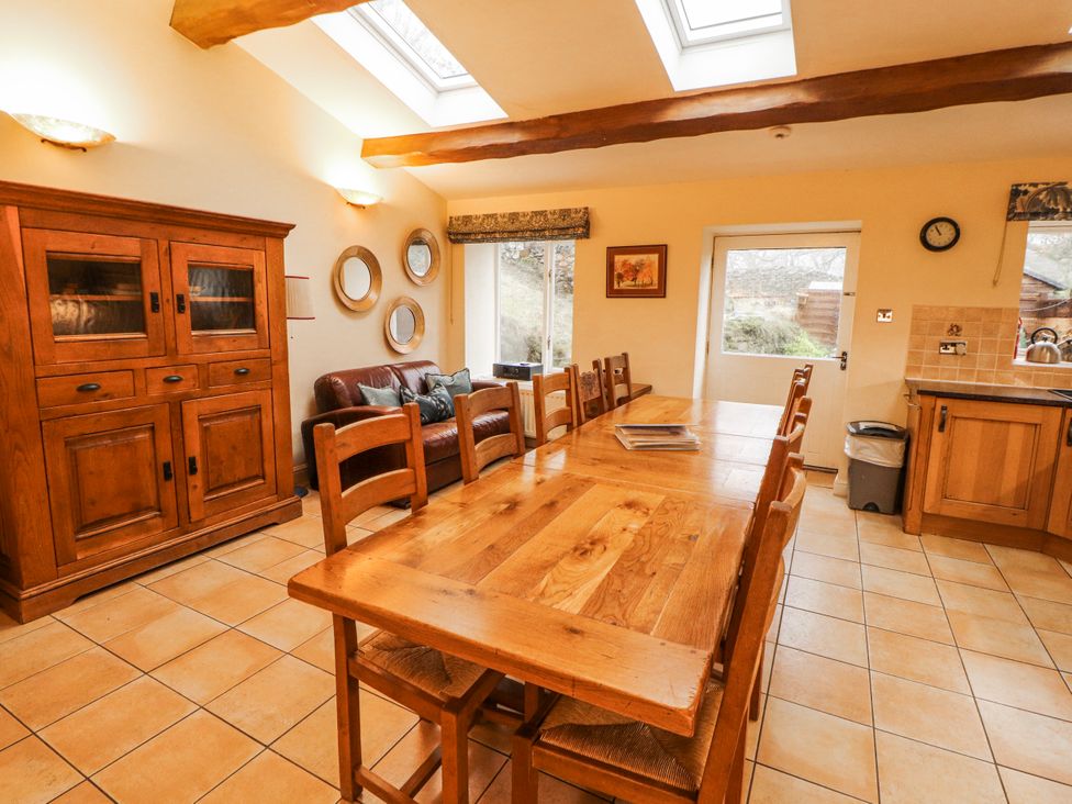 A dining room with a table and chairs at Deer How Farm Patterdale near Glenridding