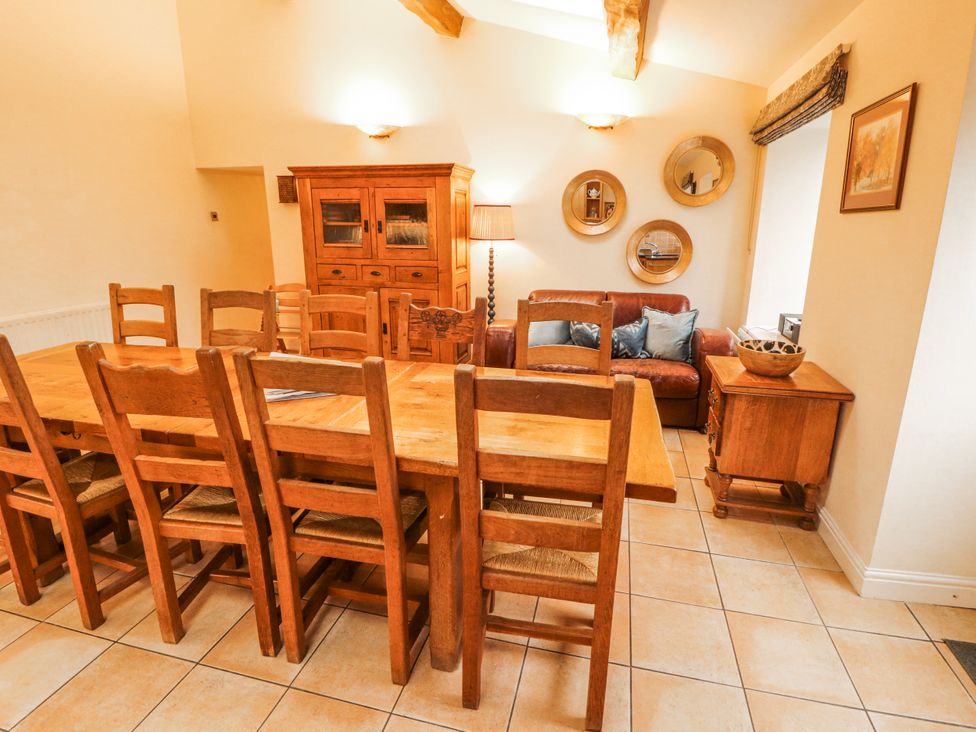 A dining room with a table and chairs at Deer How Farm in Patterdale near Glenridding